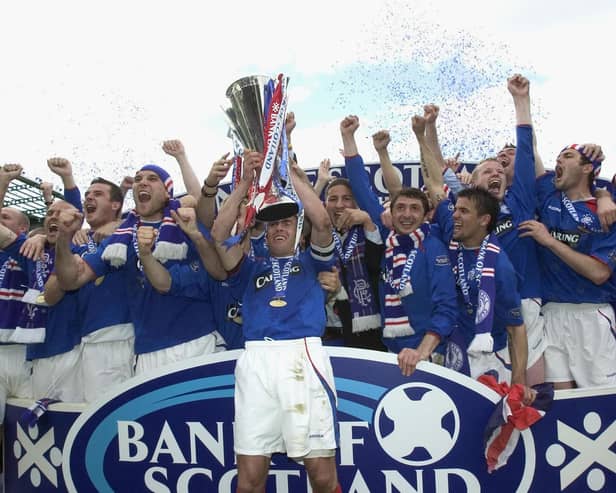 Fernando Ricksen of Rangers lifts the Scottish Premier League Trophy