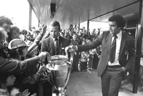 Nottingham Forest's John McGovern and goalkeeper Peter Shilton (right) show supporters the European Cup at East Midland's Airport, after their 1-0 victory in the 1980 final over Hamburg in Madrid, Spain. Pic by PA.