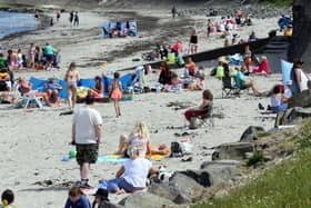Crowds of sunbathers were enjoying the sunshine at Ballygalley beach in Co Antrim today.  PICTURE BY STEPHEN DAVISON