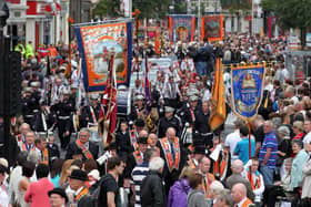 Orangemen take part in Twelfth of July parades as they make their way to the field at Shaws Bridge, Belfast