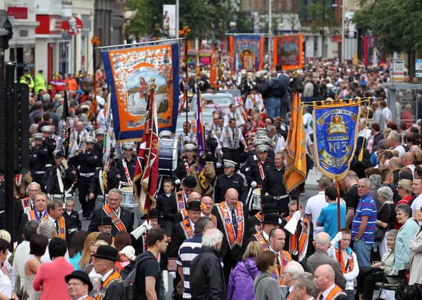 Orangemen take part in Twelfth of July parades as they make their way to the field at Shaws Bridge, Belfast