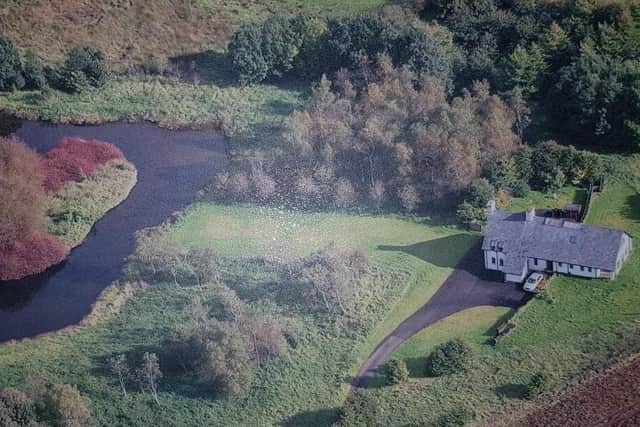 The property occupies mature, private site extending to approximately 5.44 acres, featuring a man-made lake.