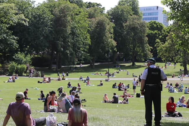 A PSNI officer surveys a crowd in Botanic Gardens to make sure everyone is adhering to social distancing rules. (Photo: PA Wire)