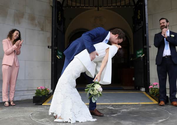 Michael McCaw, from Belfast, and Lucrecia Landeta Garcia, originally from Argentina, with their witnesses Norman Ross (right) and Ruth McNaughton (left) following their wedding ceremony at City Hall in Belfast. Picture: PA