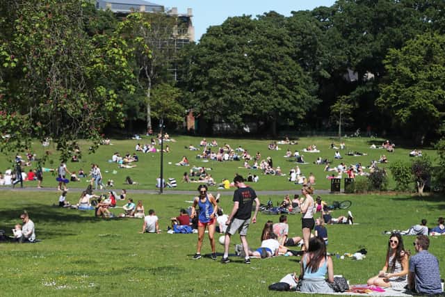 People enjoying a recent spell of warm weather in Botanic Gardens, Belfast. (Photo: PA Wire)