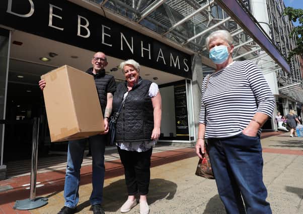 Happy shoppers leave Debenhams with a purchase as the store in Belfast’s CastleCourt reopened yesterday