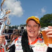 John McGuinness celebrates his 14th Isle of Man TT victory with a pint after winning the 2008 Senior race.