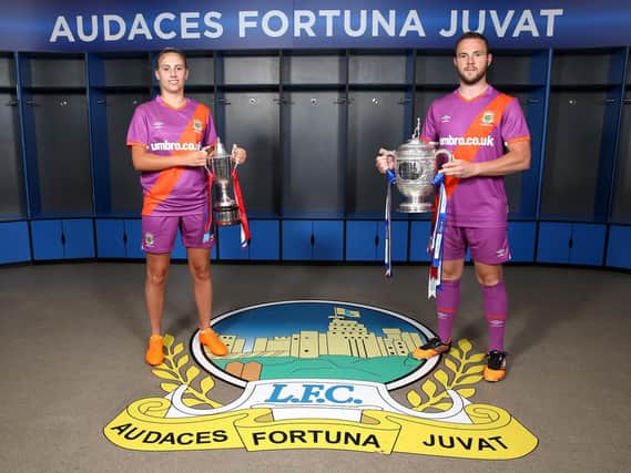 Ladies player Kelsie Burrows and Linfield club captain Jamie Mulgrew pictured at Windsor Park in the new Umbro away kit for the start of the 2020/2021 season