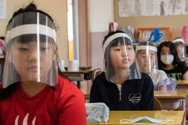 Children wearing plastic face visors sit in class at Kinugawa Elementary School in Japan, where schools have returned.
Hugh McCarthy writes: "There is a crisis looming when the children return if we continue to fill them with fear. The UK and Irish governments need to assuage fears the of the public first, then people will return willingly to the proper learning environment"