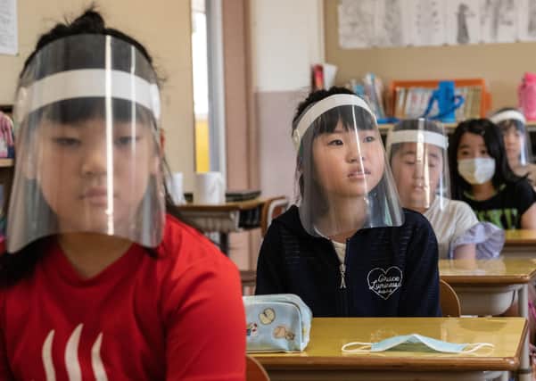 Children wearing plastic face visors sit in class at Kinugawa Elementary School in Japan, where schools have returned. 
Hugh McCarthy writes: "There is a crisis looming when the children return if we continue to fill them with fear. The UK and Irish governments need to assuage fears the of the public first, then people will return willingly to the proper learning environment"