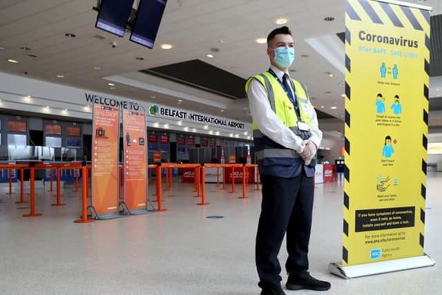 PACEMAKER, BELFAST, 11/6/2020: A member of staff at Belfast International Airport places signs to inform pasengers of the social distancing measures that have been put in place at the airport as part of the Coronavirus restrictions ahead of the re-opening on Monday morning.
PICTURE BY STEPHEN DAVISON