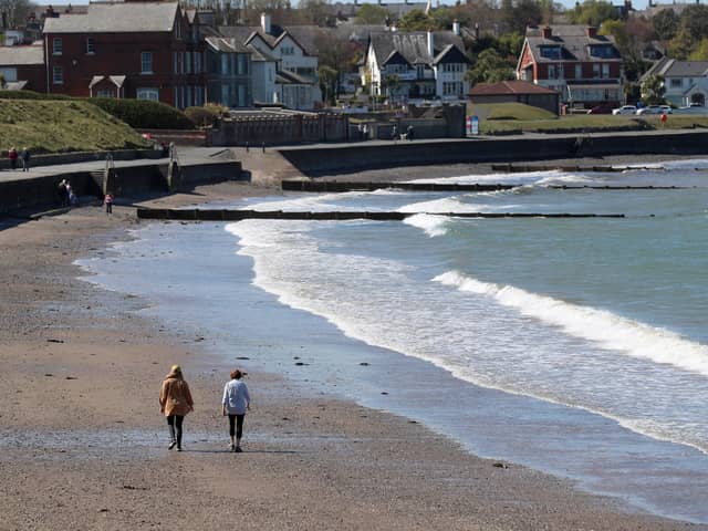 Walkers on Bangor beach enjoying the recent extended spell of good weather
