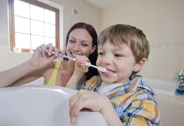 Pictured being smarter with their water is mummy Kerry Dawson showing son Eoin (5) to turn off the tap when brushing his teeth