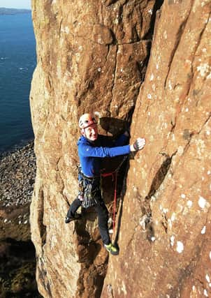 Davey Andrews climbing at Fair Head last year