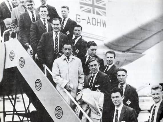 Doherty and the Northern Ireland squad prepare to board the plane to go the the 1958 World Cup finals