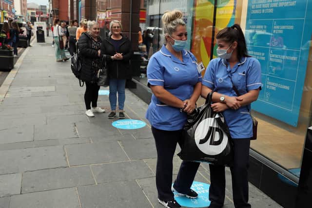 Care workers queue outside Primark in Belfast as some non-essential shops in Northern Ireland open their doors to customers for the first time since coronavirus lockdown restrictions were imposed in March.