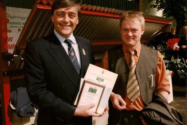 RUAS patron, the Duke of Westminster, is pictured presenting the award for second prize in the 1999 Balmoral Show Farm Inventions category to Joe Quinn of Dungannon. Joe received the award for a covered feed trough for use with diet feeder.