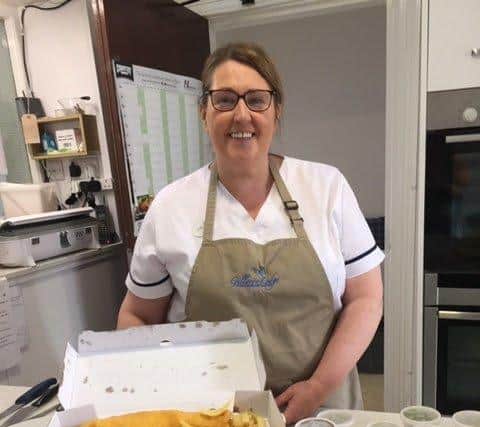 Jenny, cook manager, Gillaroo Lodge, prepares to serve up meals 'chip shop' style.