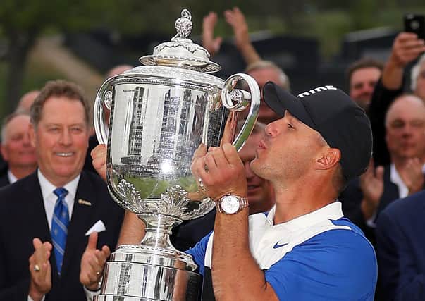 Brooks Koepka kisses the Wanamaker Trophy last year at the Bethpage Black course. Pic by Getty.