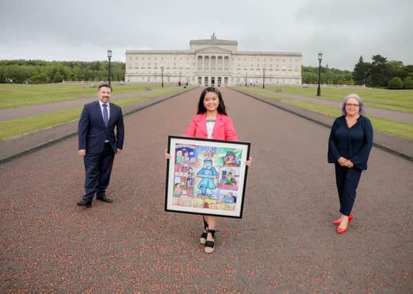 Health Minister, Robin Swann MLA accepts artwork from the Radius ‘Art from the Heart’ competition, from winning artist Shayna Velasquez and Eileen Patterson, Radius Housing Director of Communities. Inspired by the dedication and professionalism of health service staff across Northern Ireland, Shayna wanted to share her painting as a gesture of thanks to them all. Press Eye - Belfast - Northern Ireland. Photo by Philip Magowan / Press Eye