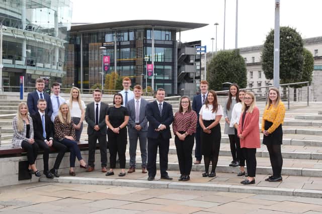 Pictured are last year’s graduate intake to KPMG in Northern Ireland with Partner John Poole, centre, outside the firm’s Soloist Building in Belfast