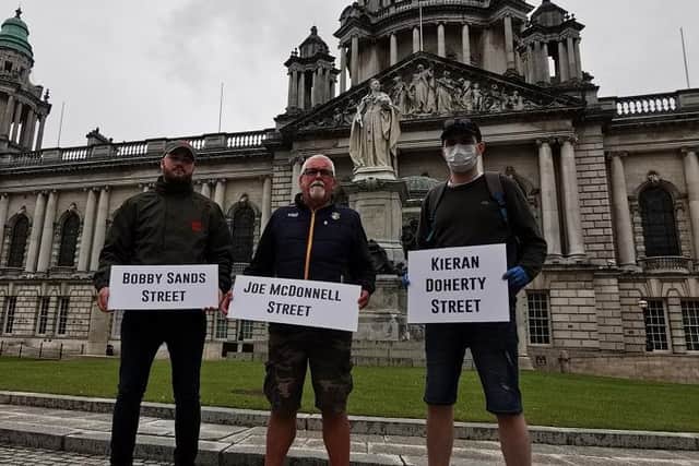 Lasair Dhearg members with their signs in Belfast city centre on Monday.