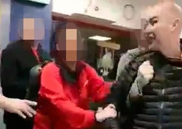 A still image from a video appears to show Sean Kelly being restrained by others after an incident at a shopping centre in May