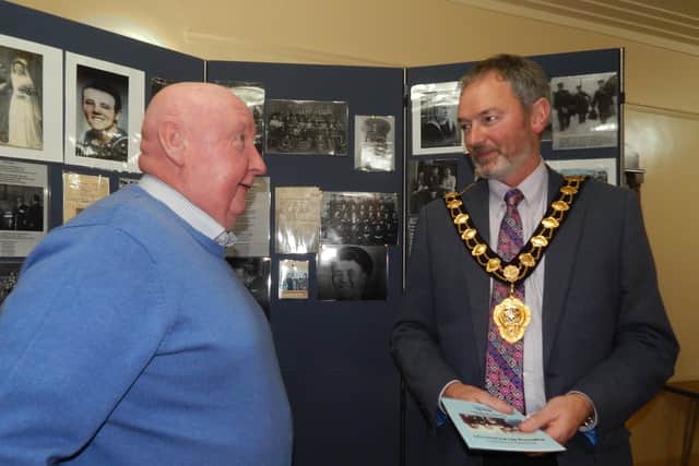 Roy Jake McAtamey, son of Bobby, chats to Mid and East Antrim Borough Mayor, William McCaughey at the booklet launch