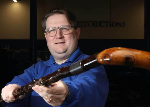 Karl Bennett of Bloomfield Auctions with the walking stick once owned by James Craig