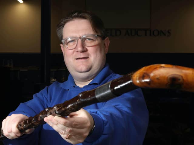 Karl Bennett of Bloomfield Auctions with the walking stick once owned by James Craig