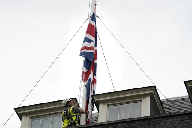 The Union flags above Downing Street have been lowered to half mast after Conservative MP Sir David Amess died, he was stabbed several times at a surgery in his Southend West constituency. Photo: Aaron Chown/PA Wire