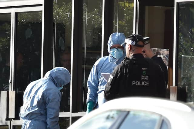 Police officers in forensic suits at the Belfairs Methodist Church in Eastwood Road North, Leigh-on-Sea, Essex, where Conservative MP Sir David Amess was killed. Photo: Nick Ansell/PA Wire