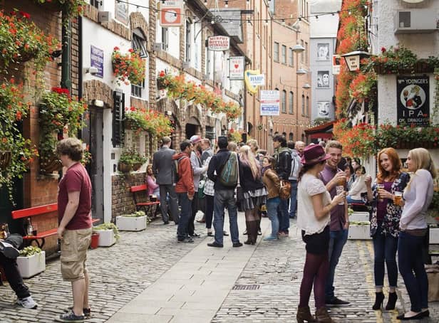 People socialise in the Cathedral Quarter of Belfast, home to a number of pubs and restaurants