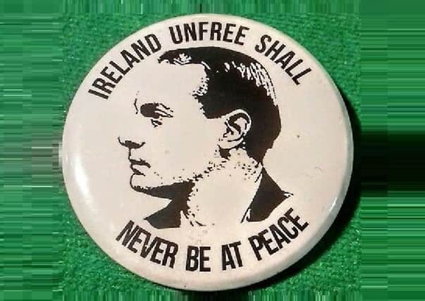 A badge with Padraic Pearse's famous phrase: Ireland unfree shall never be at peace