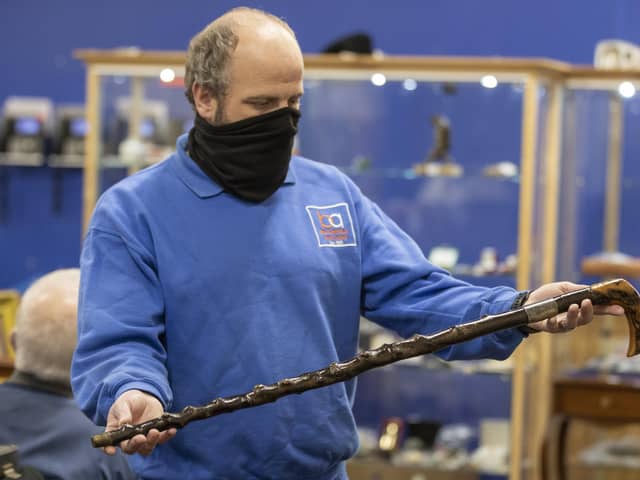 A member of the Bloomfield Auctions team in east Belfast, holds a walking stick once owned by Northern Ireland's first Prime Minister, James Craig, 1st Viscount Craigavon, which sold for £10,000 to an online bidder. It was estimated that the blackthorn cane would sell for between £4,000 and £6,000.