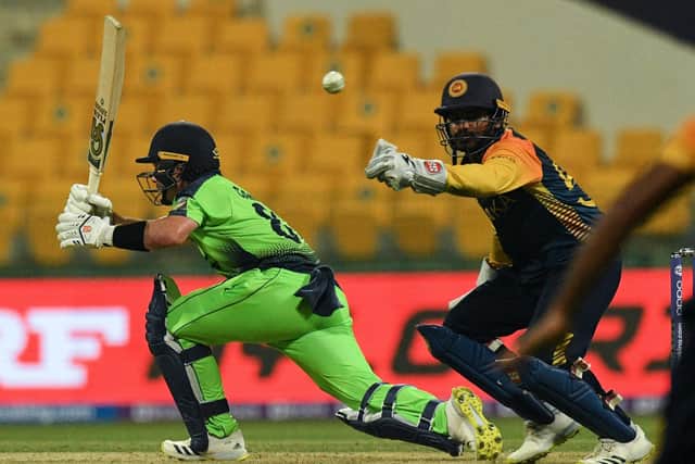 Sri Lanka's wicketkeeper Kusal Perera attemps to catch a ball from Ireland's Curtis Campher (L) during the ICC mens Twenty20 World Cup cricket match between Sri Lanka and Ireland at the Sheikh Zayed Stadium in Abu Dhabi on October 20, 2021. (Photo by INDRANIL MUKHERJEE / AFP) (Photo by INDRANIL MUKHERJEE/AFP via Getty Images)