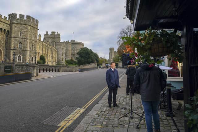 A TV news crew works outside Windsor Castle, Berkshire, after Queen Elizabeth II returned there on Thursday after spending a night in hospital for what a Buckingham Palace spokesman described as "preliminary investigations". Photo: Steve Parsons/PA Wire