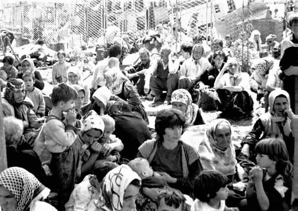 PA image: Some of the 30,000 predominantly-Muslim refugees from the eastern Bosnian enclave of Srebrenica wait for transportation on July 12, 1995. In less than a fortnight it is estimated that over 8,000 Muslim males were killed by Serb Christian forces in the area, as refugees scrambled to reach their own 'safe' ethnic enclaves following the collapse of Yugoslavia