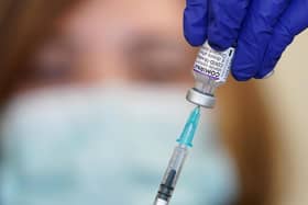 Nurse Heather Esmer draws a syringe before administering a Covid-19 vaccine