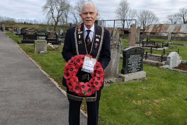 Sir Knight Sammy Nixon with a wreath which he laid on his murdered grandfather’s grave in Clogh graveyard
