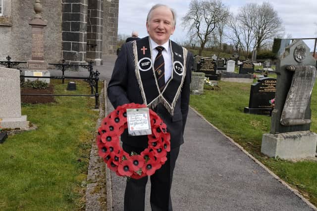 Sir Knight Nigel Leech WM with a wreath which he laid on the grave of William Gordon
