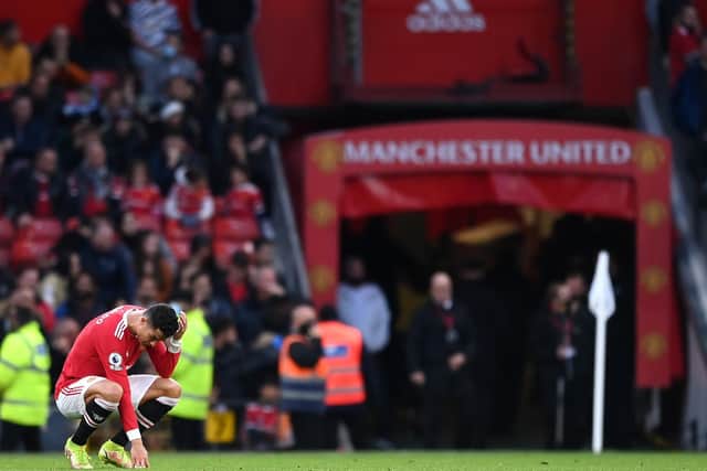 A dejected Cristiano Ronaldo looks bewildered as United slumped to a heavy defeat