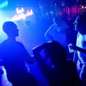 WASHINGTON, DC - JUNE 11: Patrons dance at DC9 nightclub during their Lost Birthday Club dance party on June 11, 2021 in Washington, DC.  Washington, D.C. lifted pandemic capacity limits for bars, nightclubs and music venues allowing for full capacity. (Photo by Kevin Dietsch/Getty Images)