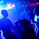 WASHINGTON, DC - JUNE 11: Patrons dance at DC9 nightclub during their Lost Birthday Club dance party on June 11, 2021 in Washington, DC.  Washington, D.C. lifted pandemic capacity limits for bars, nightclubs and music venues allowing for full capacity. (Photo by Kevin Dietsch/Getty Images)