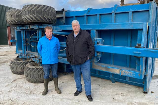 Kilkeel farmer Simon Stevenson is pictured with Mournes councillor Glyn Hanna, surveying the damage caused by the weekend's winds. This Kane trailer was blown across the yard.