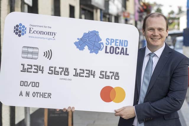 Economy Minister Gordon Lyons with a mock-up of the Spend Local card before the scheme was launched