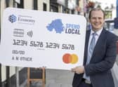 Economy Minister Gordon Lyons with a mock-up of the Spend Local card before the scheme was launched