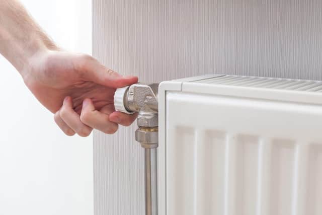 A Generic Photo of a person adjusting their radiator at home