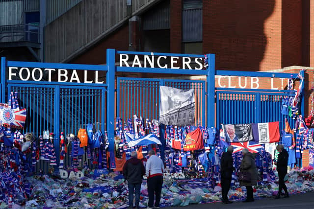Fans regard floral tributes left at Ibrox Stadium, home of Rangers FC. It was announced on 26th October 2021 that former Scotland, Rangers and Everton manager Walter Smith had died aged 73. Picture date: Wednesday November 3, 2021.