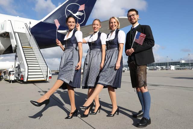 A Lufthansa Flight Crew in traditional Bavarian costume celebrate their first flight to the USA in two years.